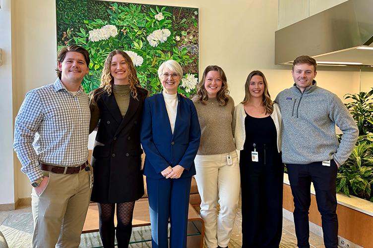 UNH President Elizabeth Chilton poses for a photo with several students